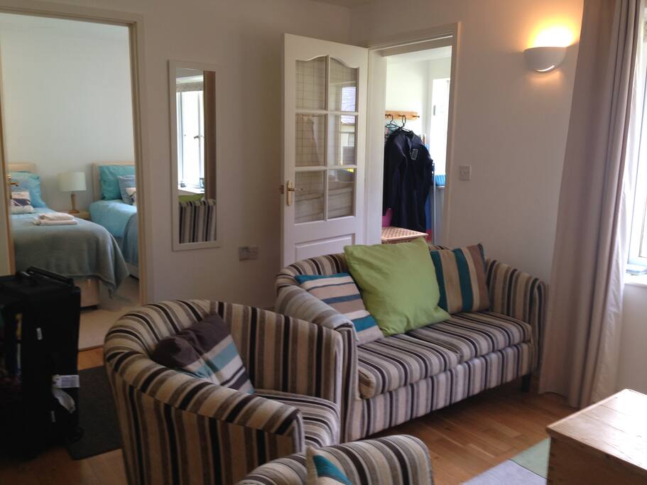 Comfortable living room with smart TV, sound system, books and games.