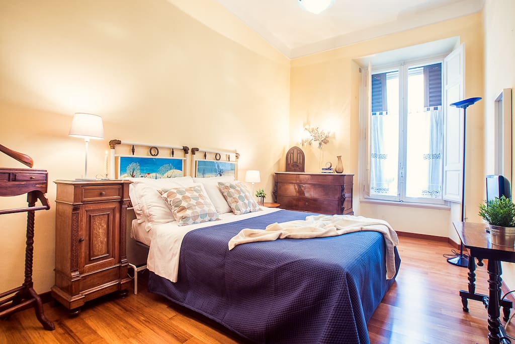 Master bedroom has plenty of light and a comfortable hand painted details on the headboard