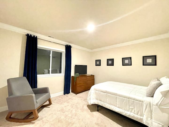 Additional bedroom on main floor offers a full size bed, rocking chair and smart TV.