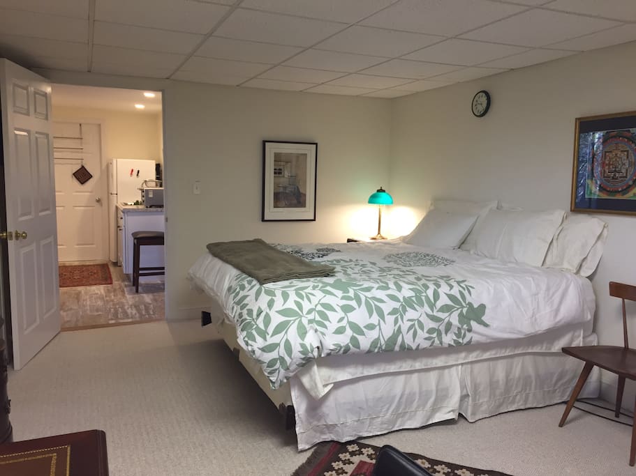 King size bed and view to separate kitchenette