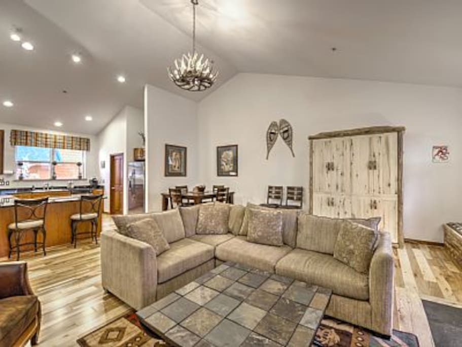 Great Room with stone fireplace, Murphy Bed, and deck.