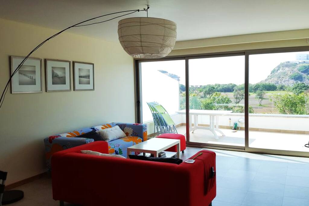 Living room overlooking the terrace/balcony and golf course