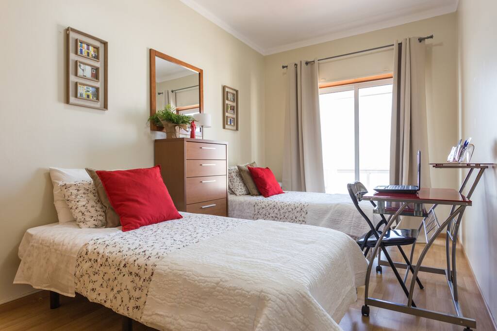 Bedroom #2 with city view. Desk with laptop for your convenience.