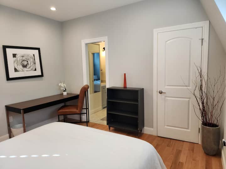 Queen bed with corner desk and corner closet. Sliding door for privacy and access to bathroom 3