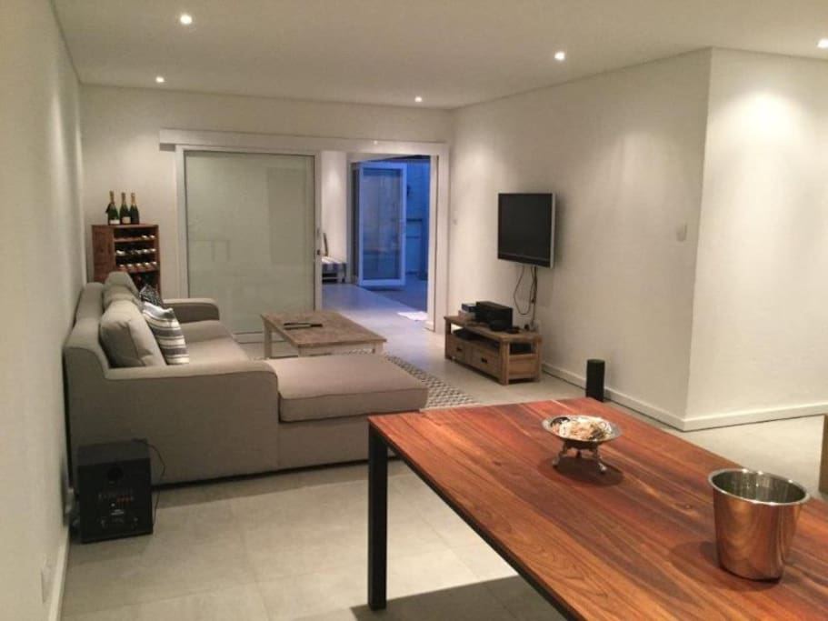 Modern open plan lounge and dining area. Leads onto kitchen as well as additional entertainment area.