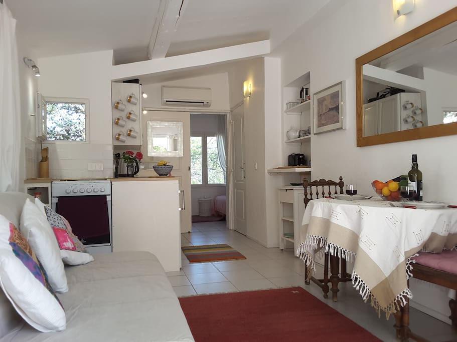 Sitting Room. This is the smallest of the apartments but it is also the most private and the lightest with lots of windowx looking out onto the pine wood and cliffs which make up the garden.