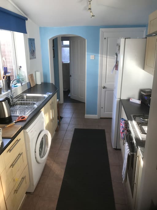 Shared kitchen leading through to shared bathroom and rear exit.