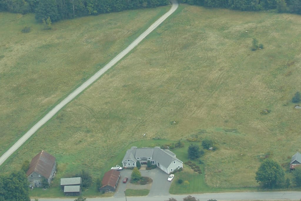 Rolling fields and woods lead to a lake