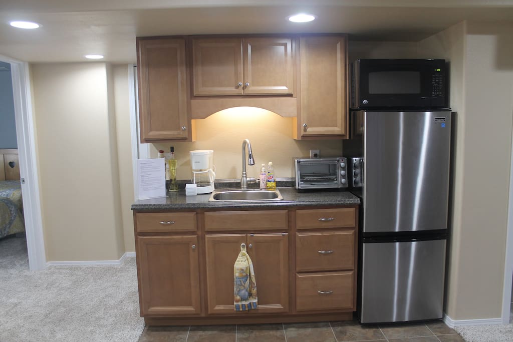 Kitchenette with refrigerator, freezer, microwave, toaster oven, 2 stovetop burners, basic coffee maker, pots/pans, dishes, silverware, etc.
