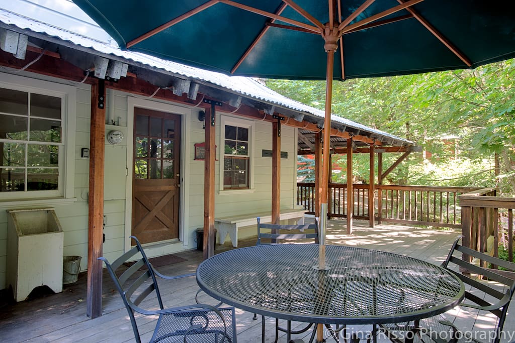 Front hardwood deck with outdoor dining table.