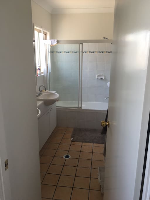 Main bathroom with two basins a shower and bath