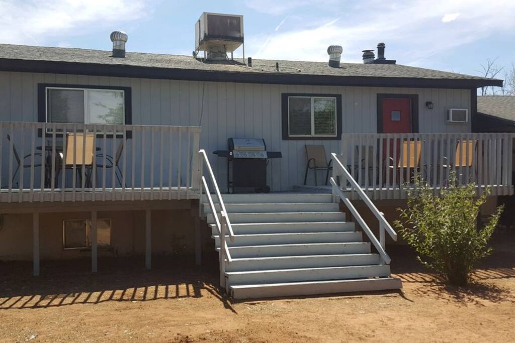 Patio with deck and bbq. Huge backyard! Plenty to do out here (ping pong, cornhole, etc)