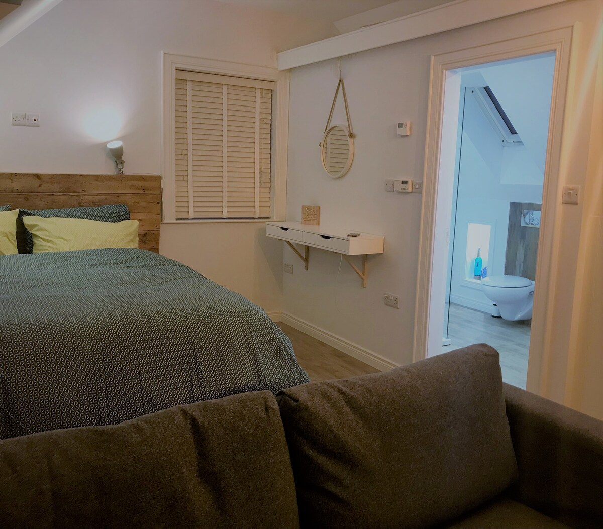 "So cozy, warm and welcoming. Loved the bed."

View of the bedroom area and connecting shower-room.