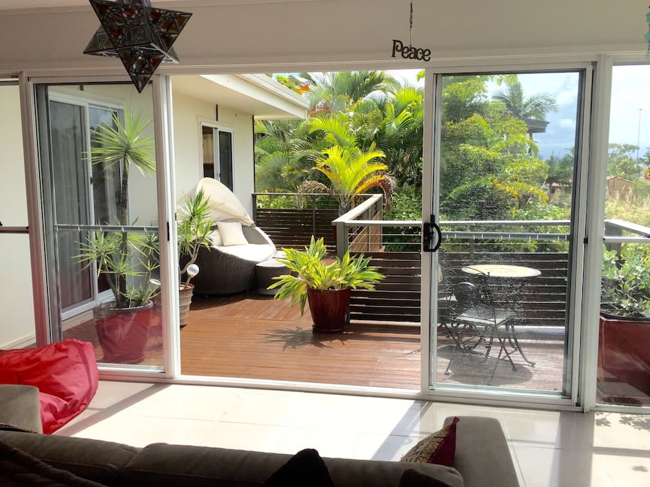 Upstairs - Beautiful front balcony - watch the sunrise on the daybed or enjoy the warmth of the east facing sun during the day!