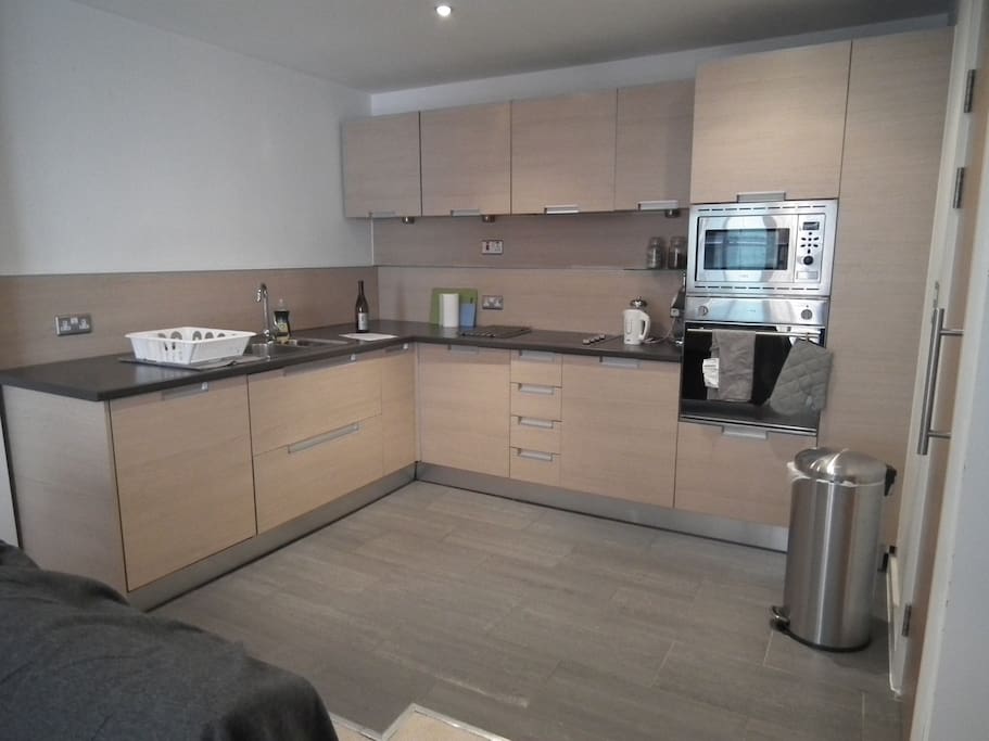 Large kitchen with microwave, oven and fridge/freezer