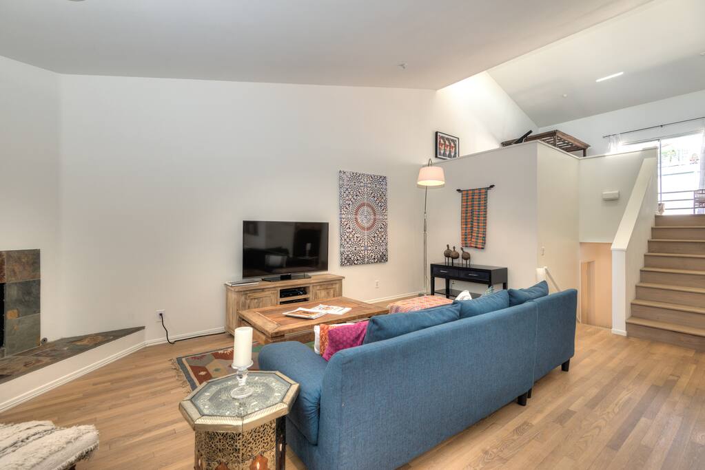 Stairs from living room to Loft space with bed and office area