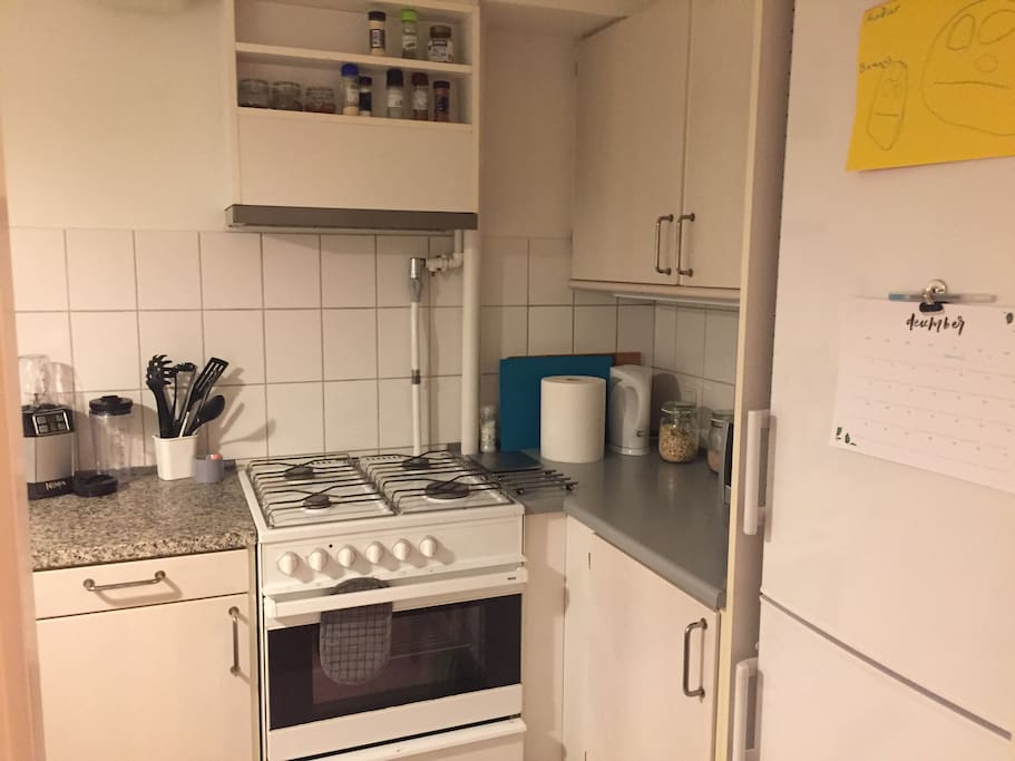 The kitchen has a gas stove and oven, and also a toaster oven, electric kettle and a blender