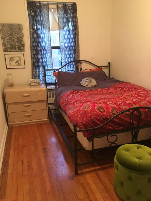 Spacious and sun filled bedroom with full bed