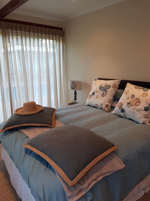 Master bedroom with king size bed, views of pool and mountain , en suite bathroom with separate bath and shower