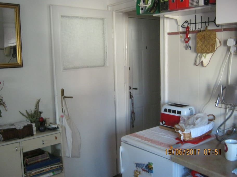 Kitchen with microwave, toaster refrigirator and kitchen sink for quick breakfast.