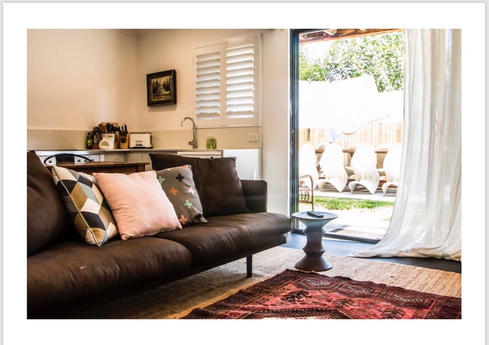 Open plan living, dining and kitchen this apartment opens to the backyard