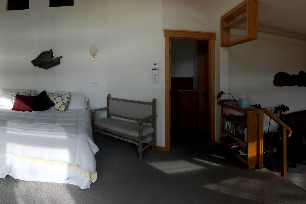 A king-size bed lies under a majestic stained-glass dome with a privileged view of the valley and Siskiyou Mountain range.