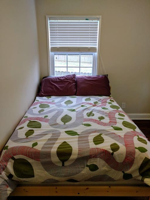 Full sized bed under large window