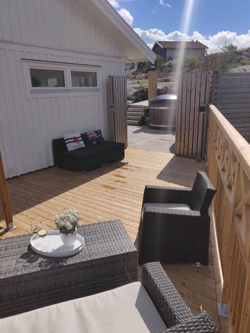 Biiiiig patio surrounding the house with hot tub (wood heated) and grill (gas/charcoal)