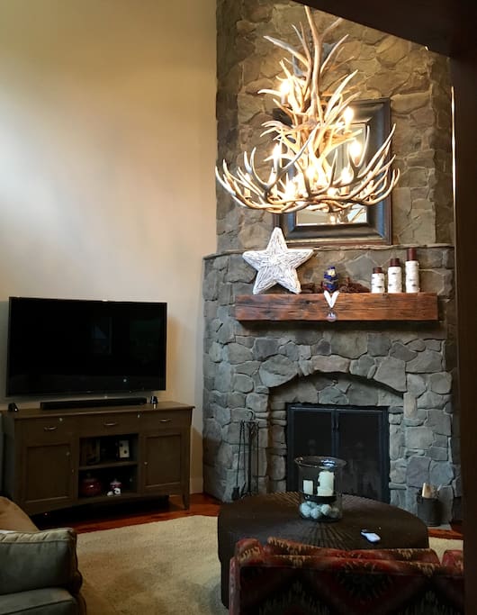 Stone fireplace and one of 4 TV's