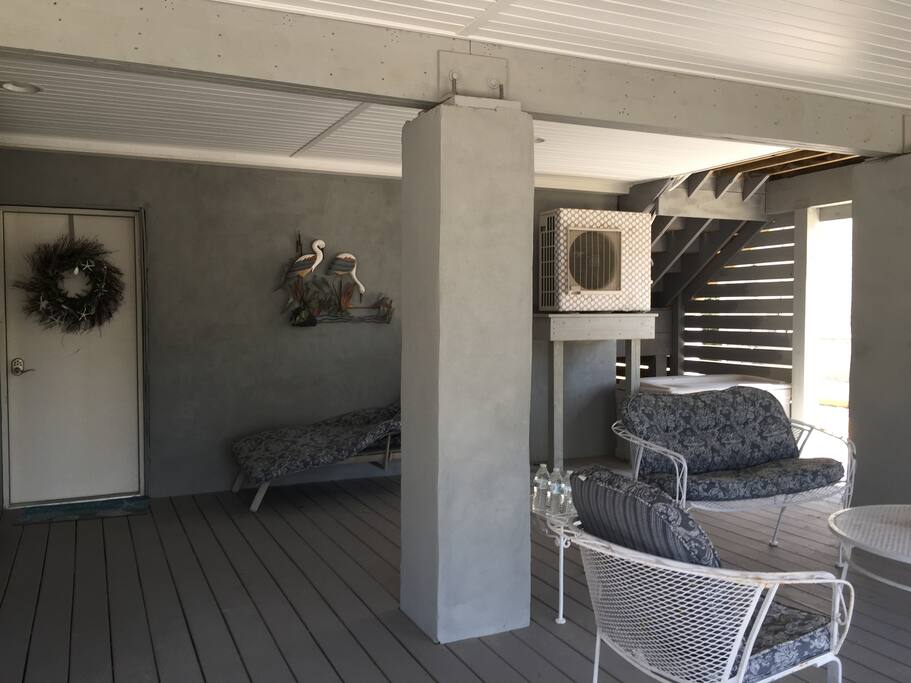 You will enter your private covered patio shown here on the right. The door on the left is the entrance To the garage with a locked door to the staircase of the efficiency.