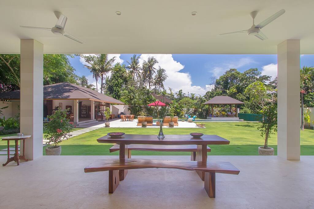 The breakfast table view of the pool house, Bale, lawn and pool.