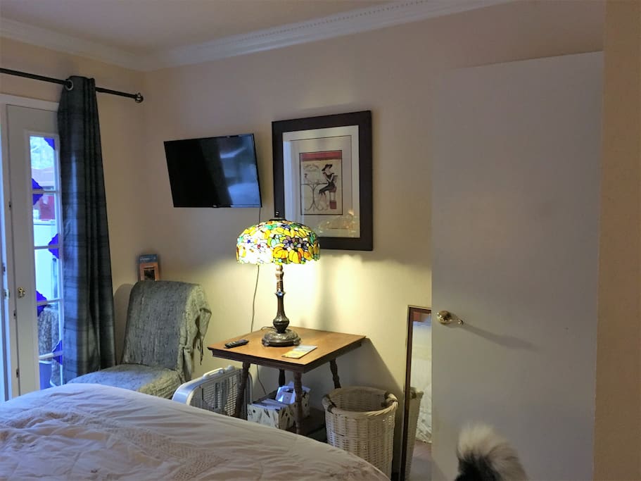 Across from the bed is a small seating area, fan and television. (We offer streaming on netflix, HBO and others)