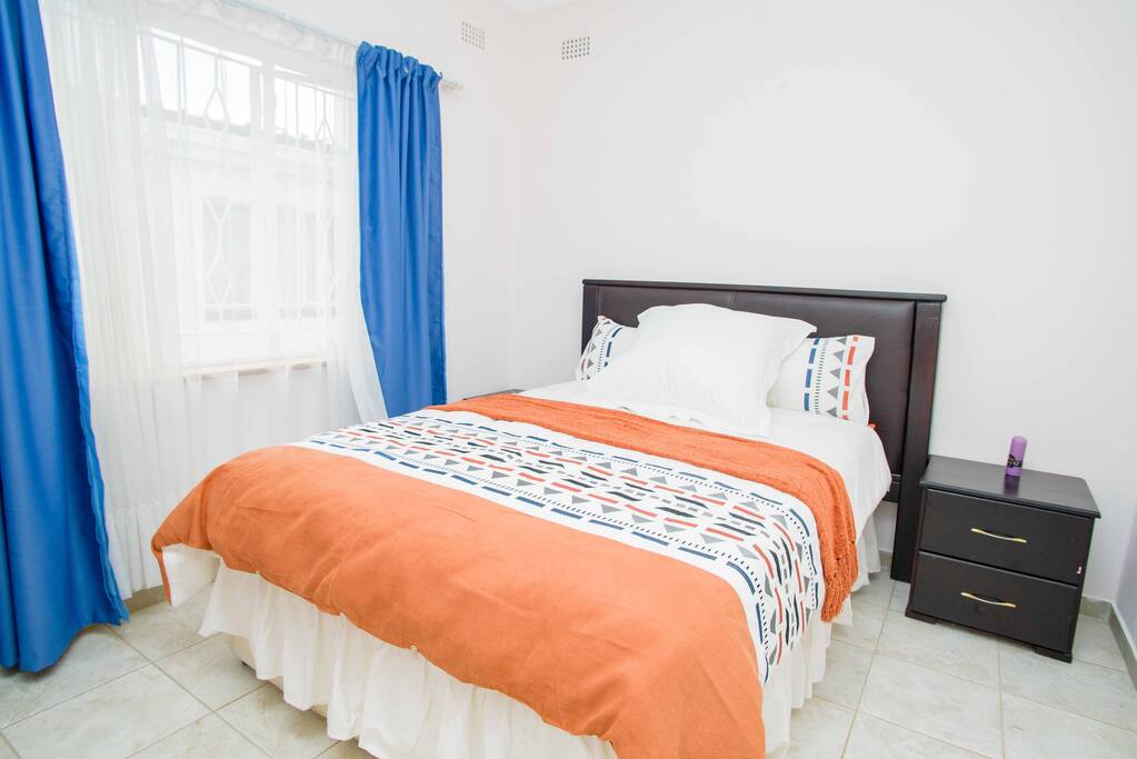 Second bedroom with double bed and cabinets.