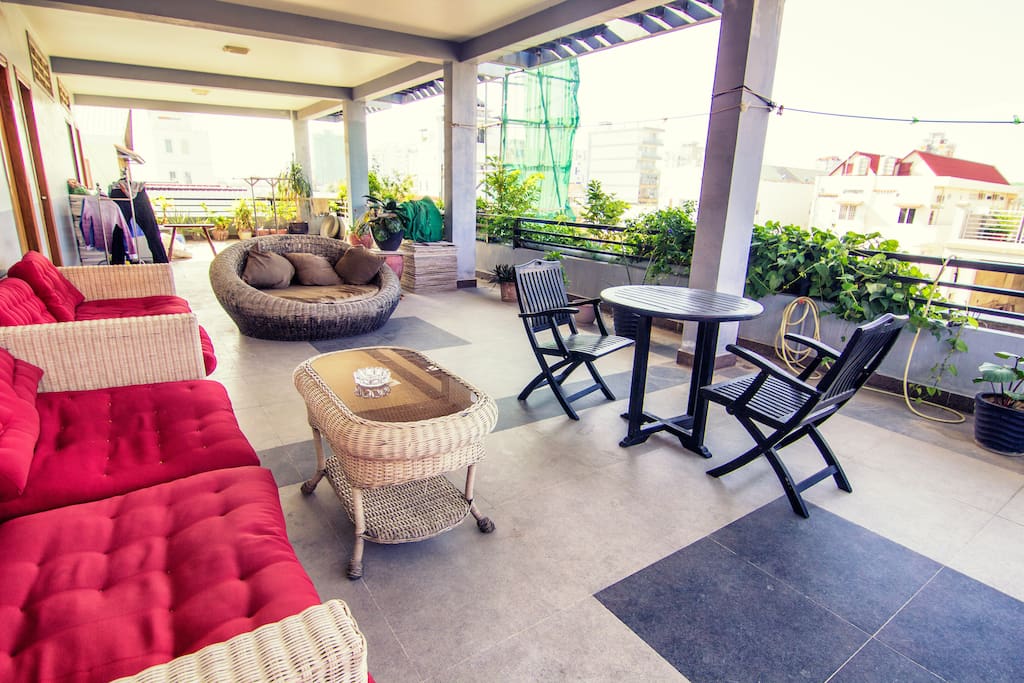 Upstairs common terrace with lots of couches and plants