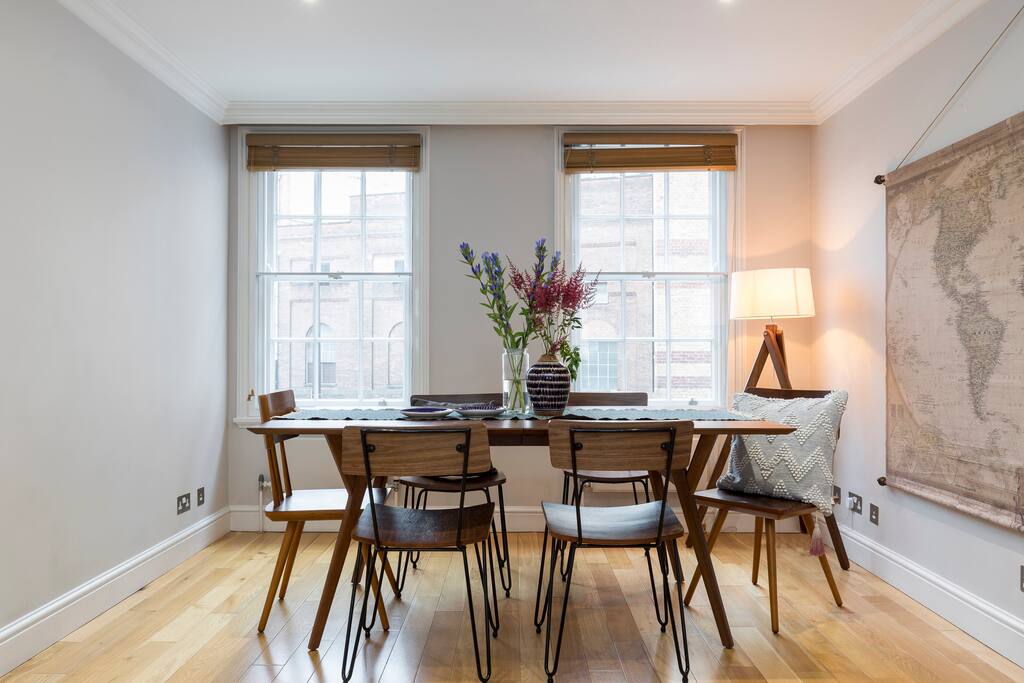The gorgeous dining area at the other end of the room gets lots of light from the large windows.