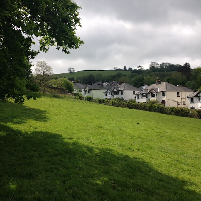 our house at the top of a hilly road, surrounded by green, but just 2 minutes walk to all the excitement of town