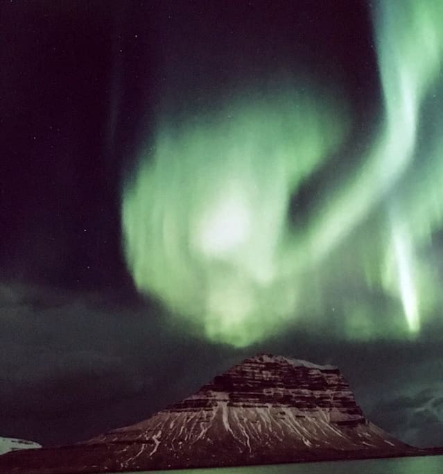 The northern lights dancing around Kirkjufell mountain.