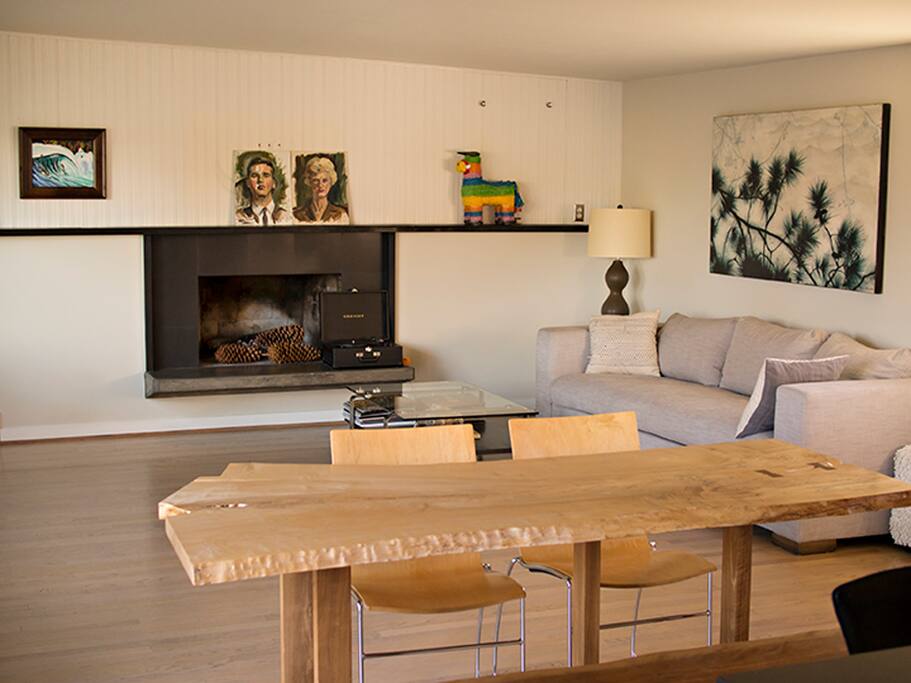 Modern open living room with no tv, lots of room for yoga, and a view of sky and trees