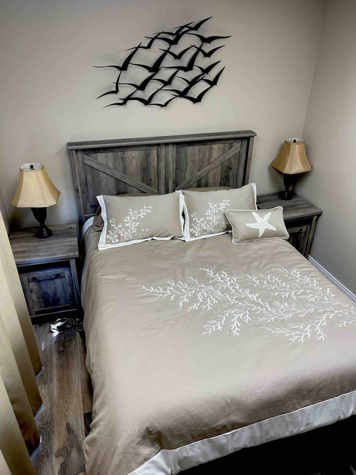 Master Bedroom with Queen bed, TV streaming ready and FREE Netflix and bedside tables with built in outlets for charging your devices.