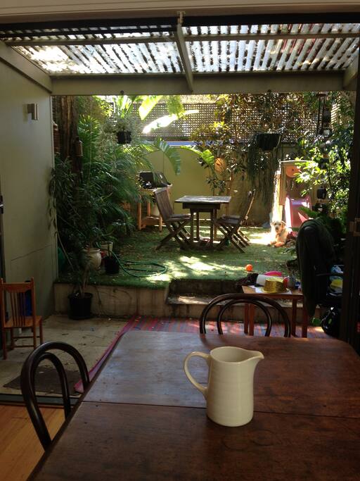 Living room/kitchen opens to sun filled garden.