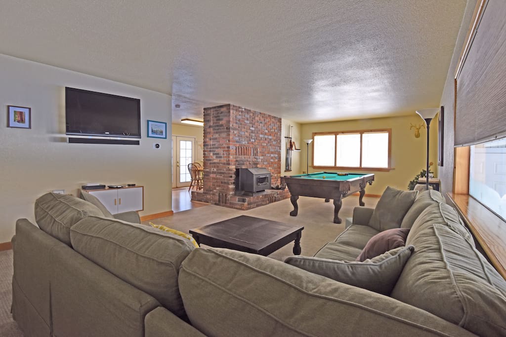 The home is outfitted for plenty of fun, with a great pool table, flatscreen TV, and cozy fireplace