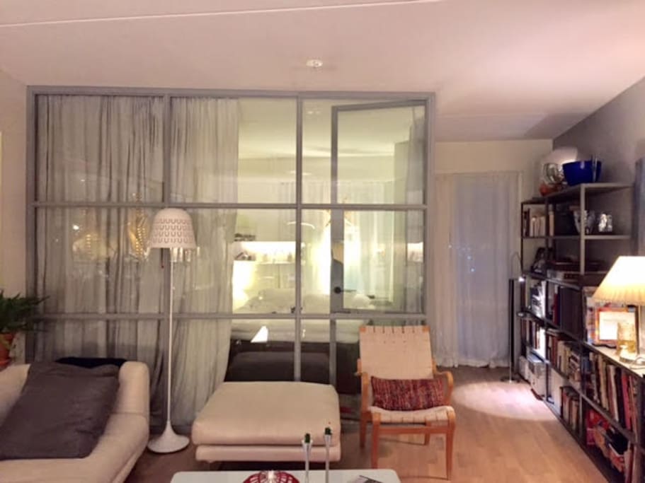Bedroom with double bed in a cosy space with curtains in linen