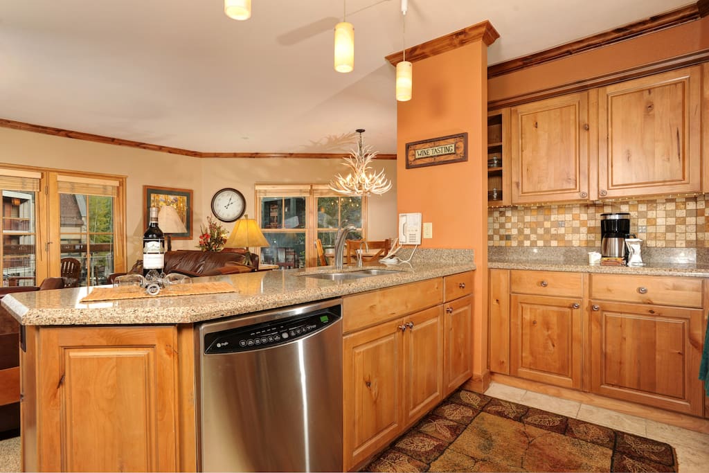 The fully-equipped kitchen features natural wood finishes and plenty of counter space