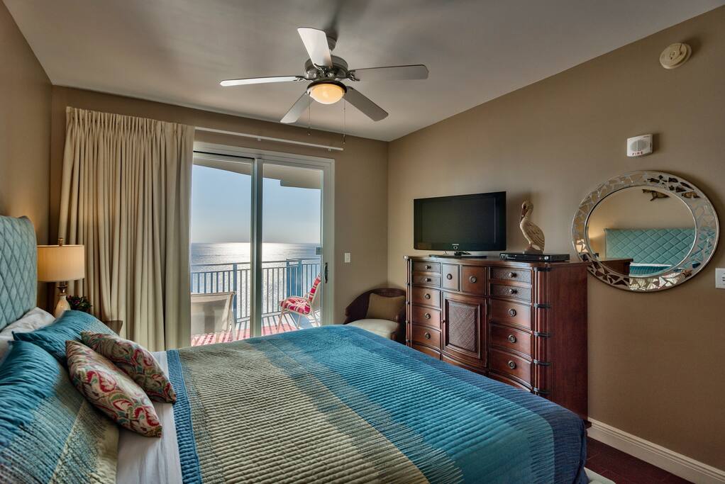 This bedroom features a flat screen TV and balcony access!