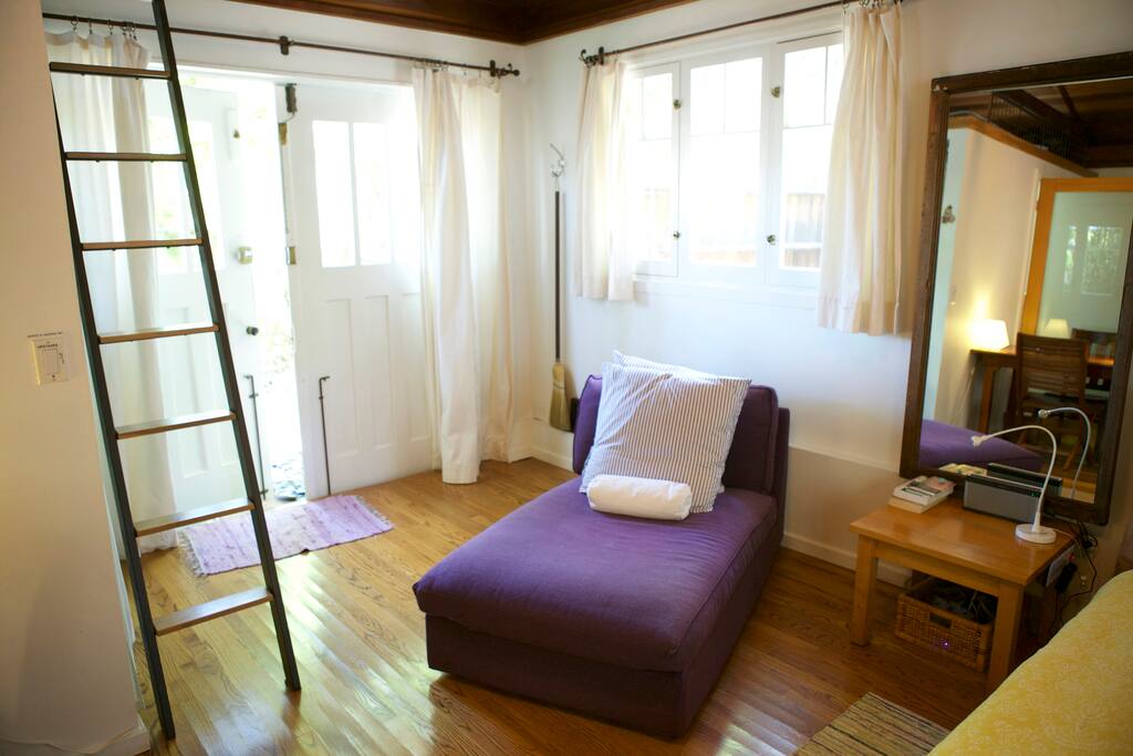 The entrance, day bed to relax, tall mirror, night stand with USB and plugs ...