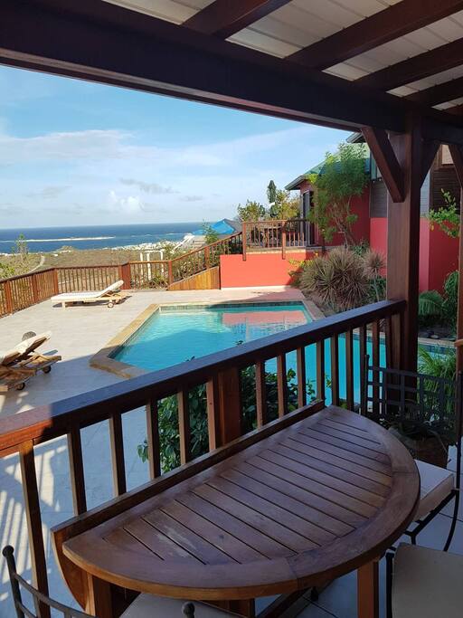 From the porch of the room, overlooking the pool and the see behind.