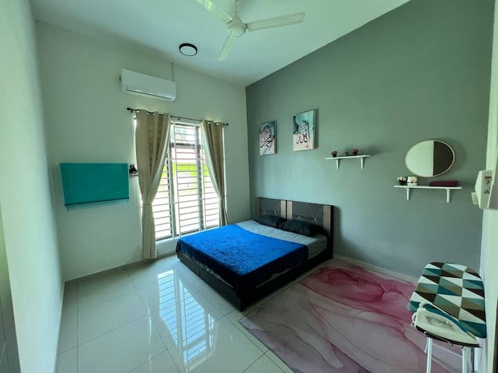 Room number 2 is equipped with air conditioner, king bed, fan, prayer mat and iron.