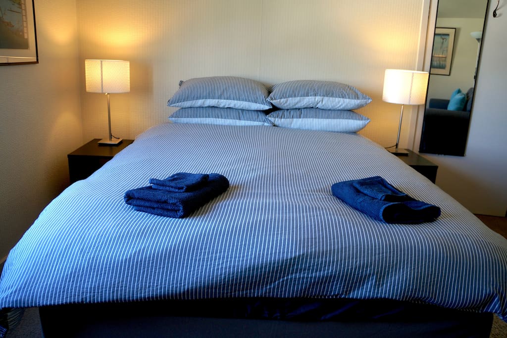 Queen-size bed with all-cotton bedding. We regularly get asked about the mattress brand - very comfy