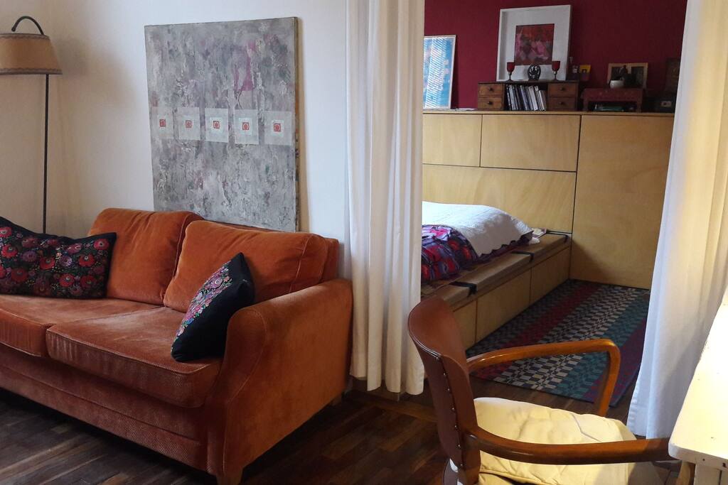 living /dining area separated with curtain from bedroom and bath.
