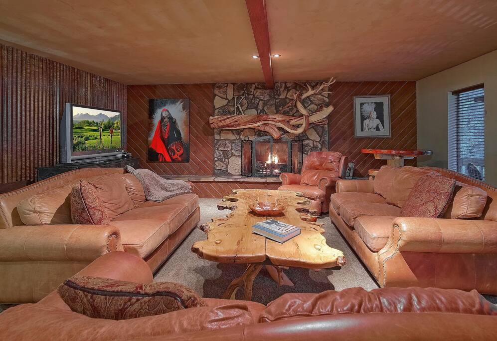 The downstairs great room with a sea of super comfy sofas, a 50″ high definition flat screen TV, HugeGas Fireplace w/remote control & No Mess To Clean Up!